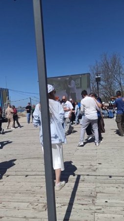 На берегу площадка для танцев- люди красиво танцуют