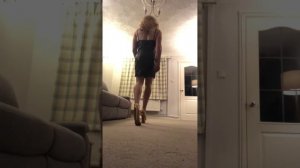 Young crossdresser in leather mini dress and 6 inch platform heels