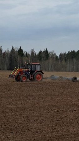 The tractor drives across the field and plows