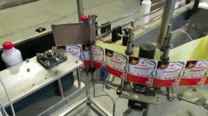 Этикет самоклейка на круглых и квадратных ПЭТ канистрах в составе автоматическая линия розлива.