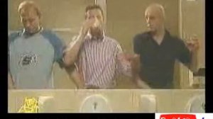 Men multi task while having a pee taken from www.britain.tv