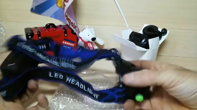 Три посылки с aliexpress: керамический нож-птичка, налобный фонарь, велофонарь.