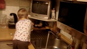 Малыш моет посуду