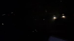 Вид из окна высокого автобуса проездом через ночной город Ростов на Дону среди ночи проспект