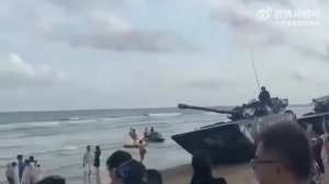 Chinese army tanks in front of Taiwan island.