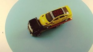 ЭВАКУАТОР С СДВИЖНОЙ ПЛАТФОРМОЙ С СПОРТ СЕДАНОМ