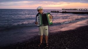 Макс играет на аккордеоне на море в Адлере