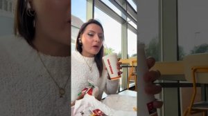 Красивая девушка танцует и кушает в мини юбке в чёрных колготках на каблуках