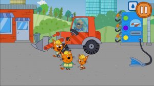 Три кота работают на стойке и собирают красную машину