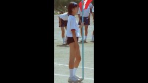 The smiling faces of four girls in cute Japanese gym uniforms