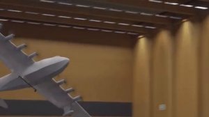 Большой радиоуправляемый самолёт с 8 электромоторами летает в зале.