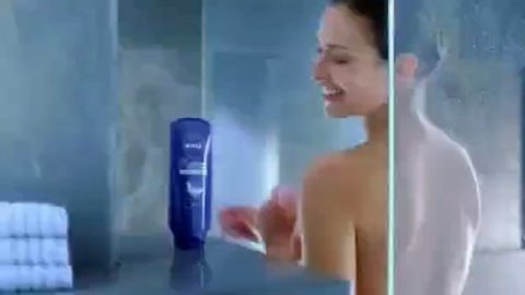 Woman takes jacuzzi in shower in early commercial