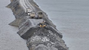 Today, many stone trucks are waiting in a row to build a road around the lake and push the stones