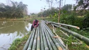 Use Large Bamboo Poles Joined Together To Creata A Walkway Across The Fish Pond