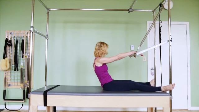 Seated Push Through on Trapeze Table/Cadillac ⎮Pilates Encyclopedia