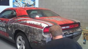 The Ugly Truth About Money car wrap with fire and ripped metal