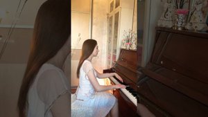 Девушка красиво играет на фортепиано.