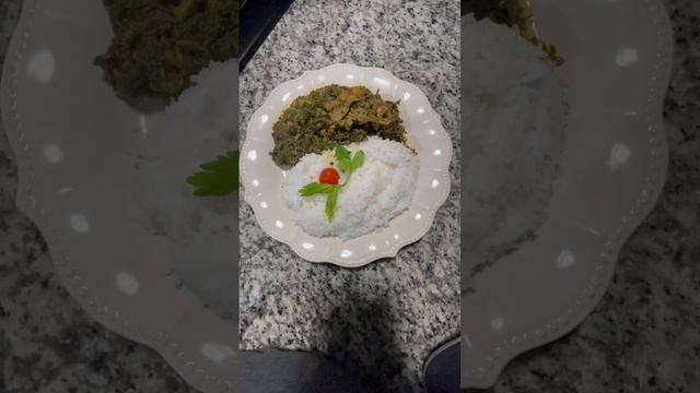 Yard fowl (chicken )callaloo with garlic, onion, ginger salt, pepper, coconut milk ￼with  rice ￼