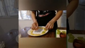 Apple, orange, plum and grapes cutting arrangement garnish the skin of plum rose design