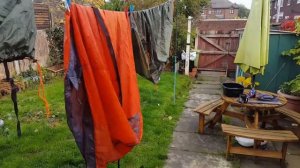 Cleaning a tent after a muddy wild camp.