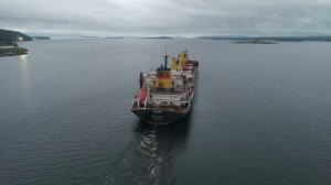 Port of Kandalaksha in Russia. Aerial. Cargo ship Viden at the exit from the port and Puma at ancho