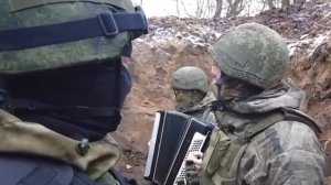 Боец на передовой играет на аккордеоне всем известный мотив ?