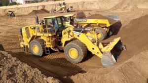 CAT 988K wheel loader loading VOLVO  A40G articulated dump trucks