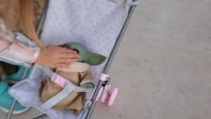 Ariya's playing with Baby Yoda. Ария играет с малышом Йодой.