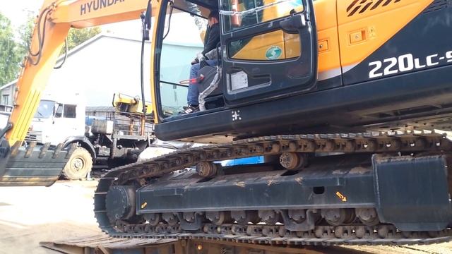 гусеничный экскаватор съезжает с трала