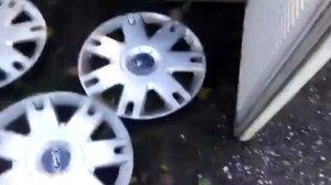 WIERD FIND!!! 3 Ford Fusion/fiesta wheel trims on a fridge