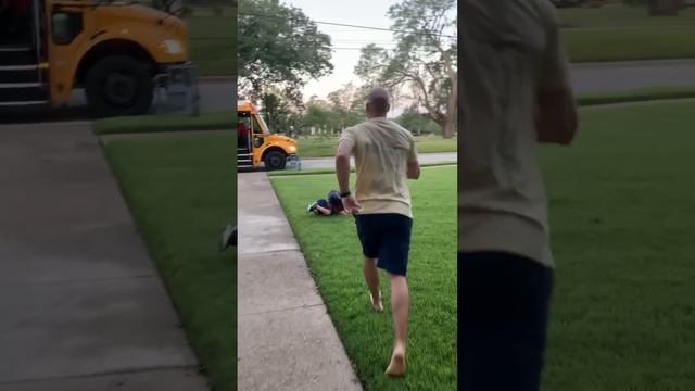 Little Boy Falls Onto Grass While Running to Catch School Bus - 1361653