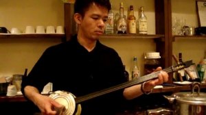 Sanshin player with home-made instrument