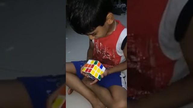 4 years old boy trying to solve Rubik's cube...