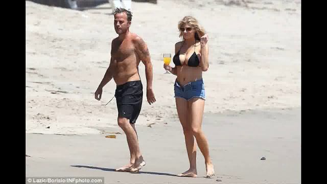 An ample handful! Charlotte McKinney gets hands on with her assets cavorting in surf wearing thong