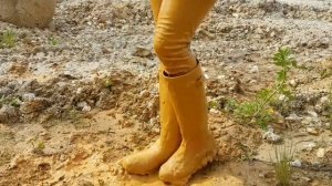 Girl in pink boots in mud