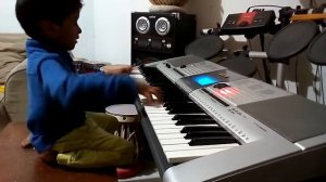 YOUNG KID PLAYING YAMAHA I-425 KEYBOARD