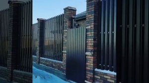 Забор из штакетника с кирпичными колоннами и откатные ворота