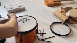 Unpacking and assembling a Rolling Rock children's drum kit