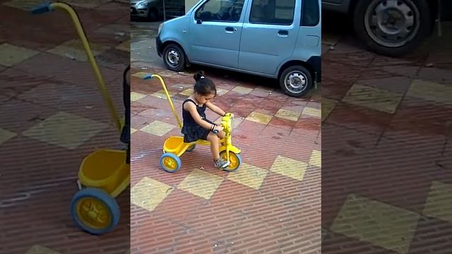 Myra on her tricycle.