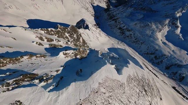 Majestic FPV Drone Journey Through Snow-Covered Peaks