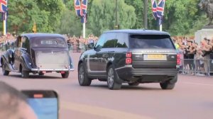 Thousands of people cheer King Charles III while his motorcade leaves the Palace