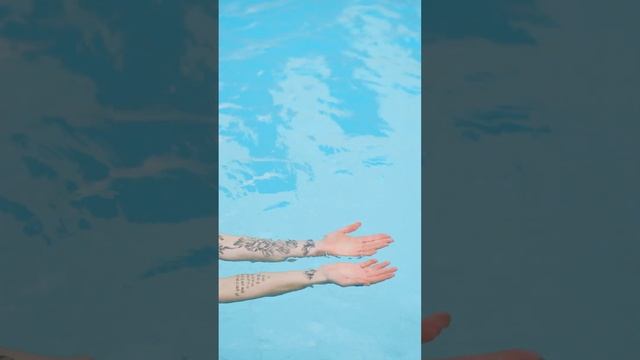 Woman Floating in a Pool Showing Her Arms and Hands [Short]