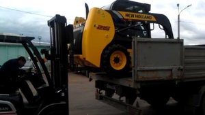 Разгрузка мини погрузчика New Holland L215