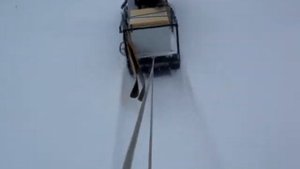 Мотобуксировщик "Ураган-промысловик" в заснеженном поле.