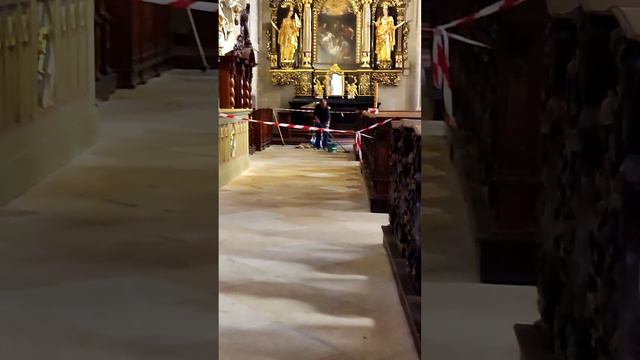 Cleaning the fireplace floor in a large church with a brush, 090723