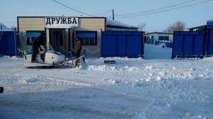 Снегоход Буран убирает снег.