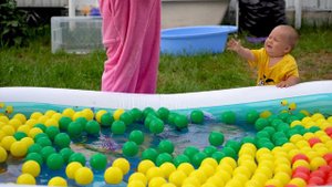 Funny Bulat We swim in the pool with colorful balls. He inflated the pool, poured water