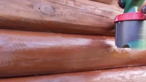 Spray painting log wall with Bosch PFS 3000-2