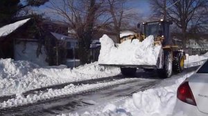 Cat 938G wheel loader clearing snow up-close