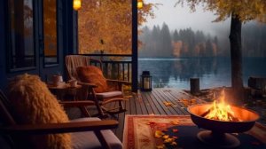 Уютная атмосфера осеннего утра на берегу озера с падающими листьями, костром и сверчками.